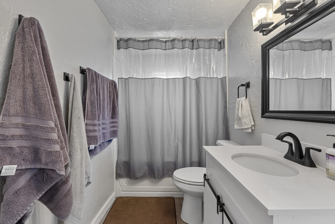Updated full bath with modern white vanity