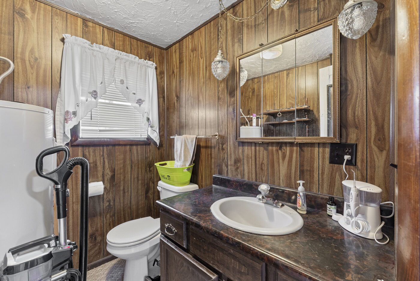 Half bath with wood paneling